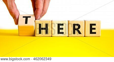 There Or Here Symbol. Businessman Turns A Wooden Cube, Changes The Word 'there' To 'here'. Beautiful