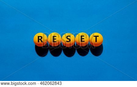 Reset Symbol. The Concept Word 'reset' On Orange Table Tennis Balls. Beautiful Blue Table, Blue Back