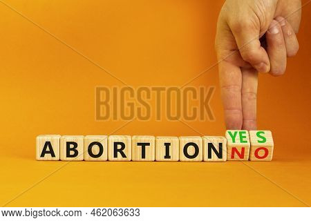 Abortion Yes Or No Symbol. Concept Words Abortion Yes Or Abortion No On Wooden Cubes. Doctor Hand. B