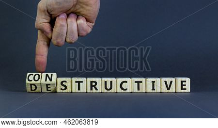 Destructive Or Constructive Symbol. Businessman Turns Cubes And Changes The Concept Word Destructive