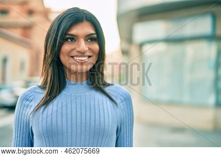 Beautiful hispanic woman smiling confient at the city