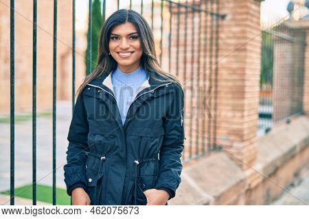 Beautiful hispanic woman smiling confient at the city