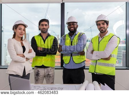 Team Engineers With Draft Plan Of Building On Constructing Site. Engineer Work On Site. Engineer Vis