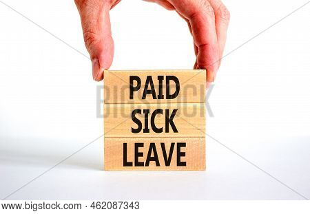 Paid Sick Leave Symbol. Concept Words Paid Sick Leave On Wooden Blocks. Doctor Hand. Beautiful White