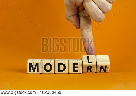 Modern Model Symbol. Businessman Turns Wooden Cubes And Changes The Word 'model' To 'modern'. Beauti