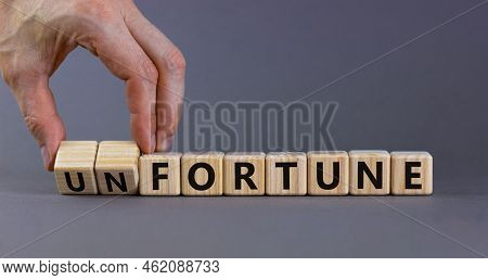 Fortune Or Unfortune Symbol. Businessman Turns Wooden Cubes And Changes The Concept Word Unfortune T