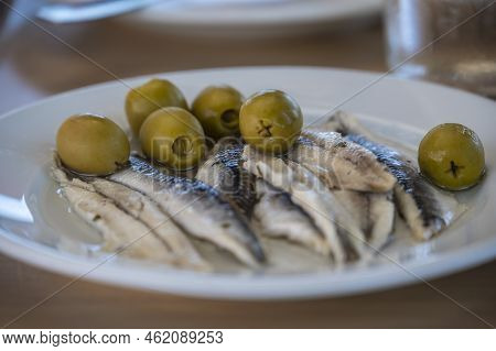 A Plate Of Anchovies And Olives. A Typical Tapas Dish In Spain.
