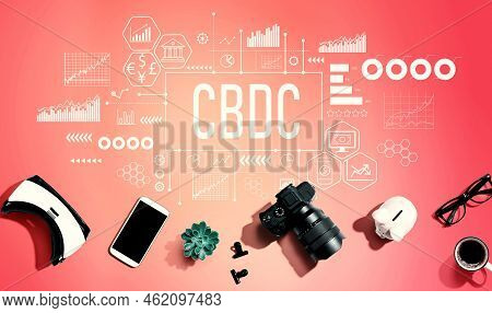 Cbdc - Central Bank Digital Currency Concept With Electronic Gadgets And Office Supplies - Flat Lay