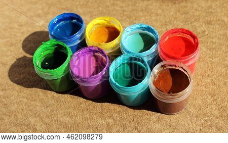 Acrylic Paints In Jars. Photo Of Opened Pots With Different Colors Of Paint