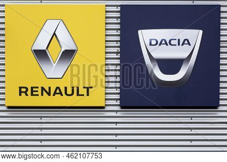 Risskov, Denmark - July 25, 2020: Renault And Dacia Logos On A Wall. The Romanian Car Manufacturer D
