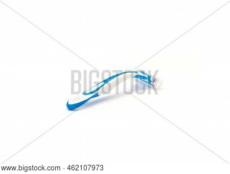 Single Brand New Blue And White Plastic Disposable Razor With Ergonomic Handle Isolated On White Bac