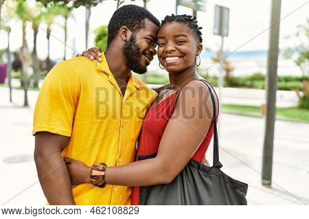 Young afircan american couple smiling happy and hugging at the city.
