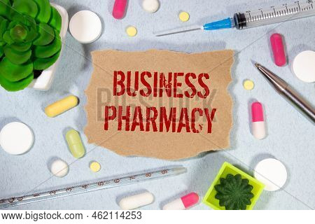 Medicine Concept. On The Blue Surface Lies A Jar Of Pills And A Clip With Paper On Which Is Written 