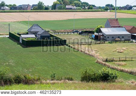 Tielt-winge, Flemish Brabant, Belgium,  08 22 2022 - High Angle View Over Farmhouses And Agriculture