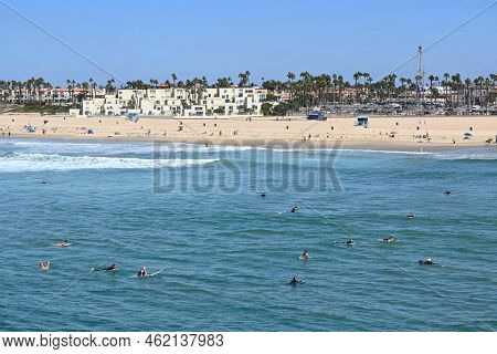 HUNTINGTON BEACH, CALIFORNIA, 19 SEPT 2022: A large group of surfers on their boards off the pier in Huntington Beach during the International Surfing Asscoiation (ISA) World Games.