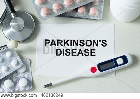 Card With Words Parkinson S Disease On The Table Next To A Stethoscope, Thermometer And Pills. Medic