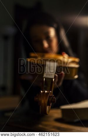 Young Woman Apprentice Violinmaker Checking Her Violin