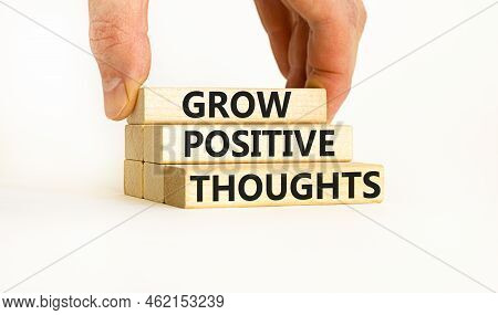 Grow Positive Thoughts Symbol. Concept Words Grow Positive Thoughts On Blocks. Businessman Hand. Bea