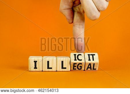 Illegal Or Illicit Symbol. Businessman Turns Wooden Cubes And Changes The Concept Word Illegal To Il