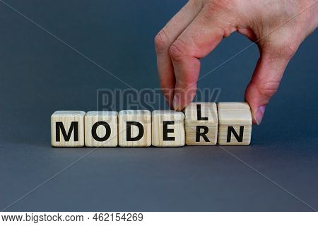 Modern Model Symbol. Businessman Turns Wooden Cubes And Changes The Word 'model' To 'modern'. Beauti