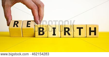 Birth Or Rebirth Symbol. Businessman Turns Wooden Cubes And Changes The Word Birth To Rebirth. Beaut