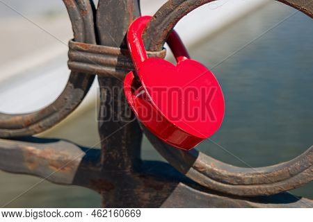 Love Lock Heart Shape Of Red Color Hanging On Bridge. Old Castom To Hand On Bridge The Locks Symboli