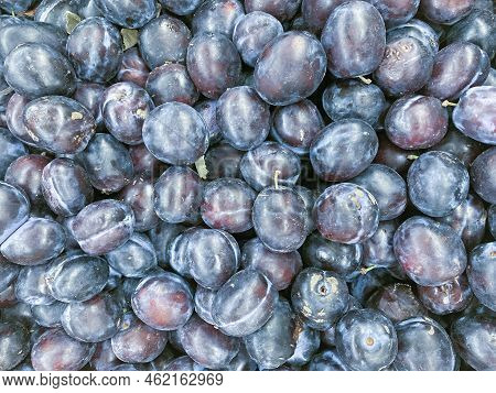 Ripe Plums. Plum With A Few Leaves. Close Up Of Fresh Plums, Top View. Macro Photo Food Fruit Plums.