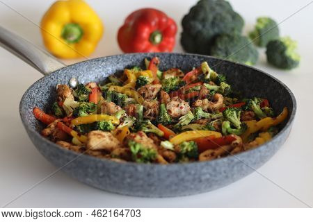 Stir Fried Vegetables With Chicken In Frying Pan. Air Fried Chicken Cubes Tossed With Sauteed Bell P