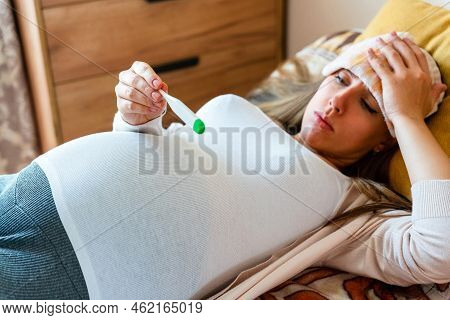 Pregnancy Health Temperature Check. Pregnant Woman Holding Thermometer, Check Fever Flu Temperature.