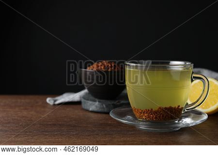 Buckwheat Tea And Granules On Wooden Table, Space For Text