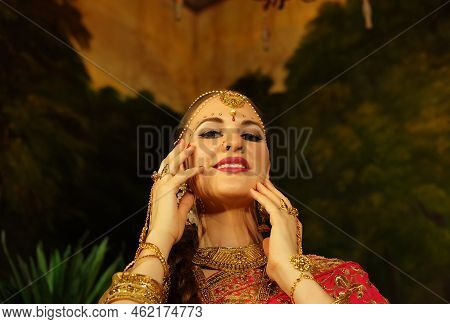 Portrait Of Beautiful Indian Female. Young Hindu Woman Model In Sari And Kundan Jewelry.
