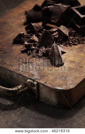 Pieces Of Dark Chocolate  On A Wooden Background
