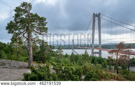 Hogakustenbron, Suspension Bridge In The High Coast Area In Sweedn On A Cloudy Day. Hoga Kusten Trai