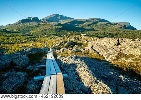 Wooden Walk Leading Across Marshlands To Nieras Massive In The Stora Sjofallet National Park, Sweden
