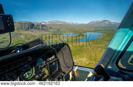 View From Cockpit Of Small Helicopter On Lakes And Mountains In Vast Arctic Landscape. Risjakjavrre 
