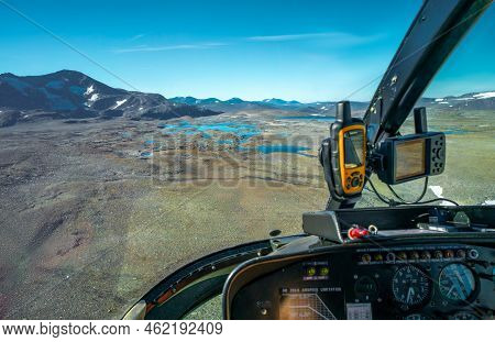 View From Cockpit Of Small Helicopter On Lakes And Mountains In Vast Arctic Landscape. Balgatjavrasj