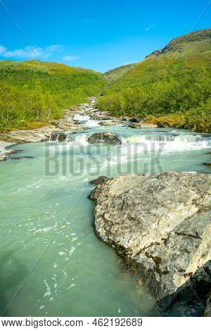 Wild Glacial River Winding Through Green Remote Arctic Landscape. Balgatjahka River In Sarek Nationa