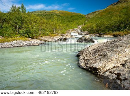 Wild Glacial River Winding Through Green Remote Arctic Landscape. Balgatjahka River In Sarek Nationa