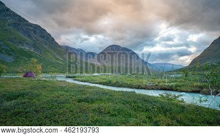 Outdoor Tent In The Remote Arctic Valley Under Tall Mountains Of Sarek National Park, Lapland, Swede