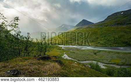 Dramatic Light And Clouds Over Ermote Arctic Valley On A Cloudy Day Of Summer. Wild River Winds Thro