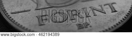 Hungarian Coin Of 10 Forints Lies On Dark Surface Close-up. Money Of Hungary. News About Economy Or 