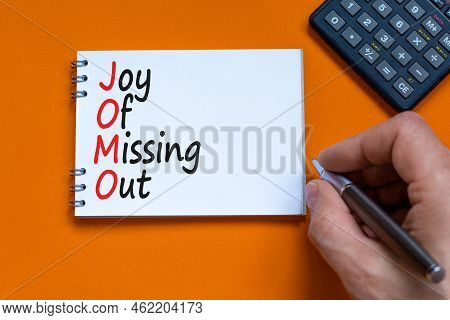 Jomo Joy Of Missing Out Symbol. Concept Words Jomo Joy Of Missing Out On The Note On A Beautiful Ora