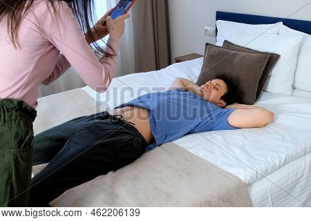 Young Happy Man On Vacation Jumping And Falling On The Bed With A Run In The Hotel Room In Slow Moti