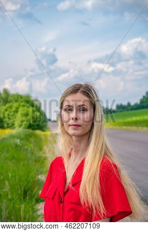 Beautiful Girl On The Road In A Red Dress. Sunbeams, Glare, Light Leaks And Sun Rays. Young Woman Fe