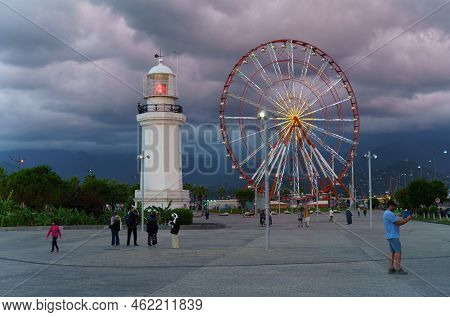 Batumi, Georgia, Ajaria - September 06, 2022: View Of The Lighthouse And Ferris Wheel On The Embankm
