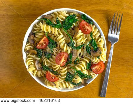 Rotini Pasta Salad Consisting Of Sauteed Mushrooms And Spinach With Tomatoes,