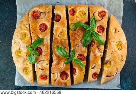 Homemade Italian Focaccia Top View. Focaccia With Tomatoes And Garlic. Food Background.