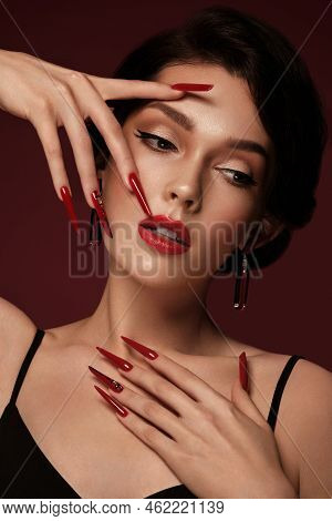 Beautiful Redhair Model: Curls, Bright Gold Makeup, Long Nails And Red Lips. The Beauty Face. Manicu