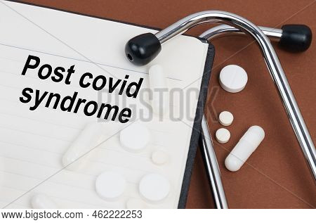 Medical Concept. On A Brown Surface Lies A Stethoscope, Pills And A Notepad With The Inscription - P