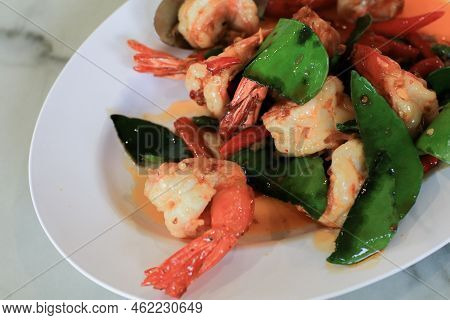 Stir Fried Shrimp Or Prawns With Chili And Kaffir Lime Leaves On White Plate. ฏelicious Thai Food.